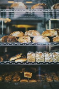 A variety of freshly baked bread displayed in a Warsaw bakery window.