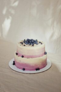 Two-tier blueberry cake with creamy frosting, perfect for celebrations.